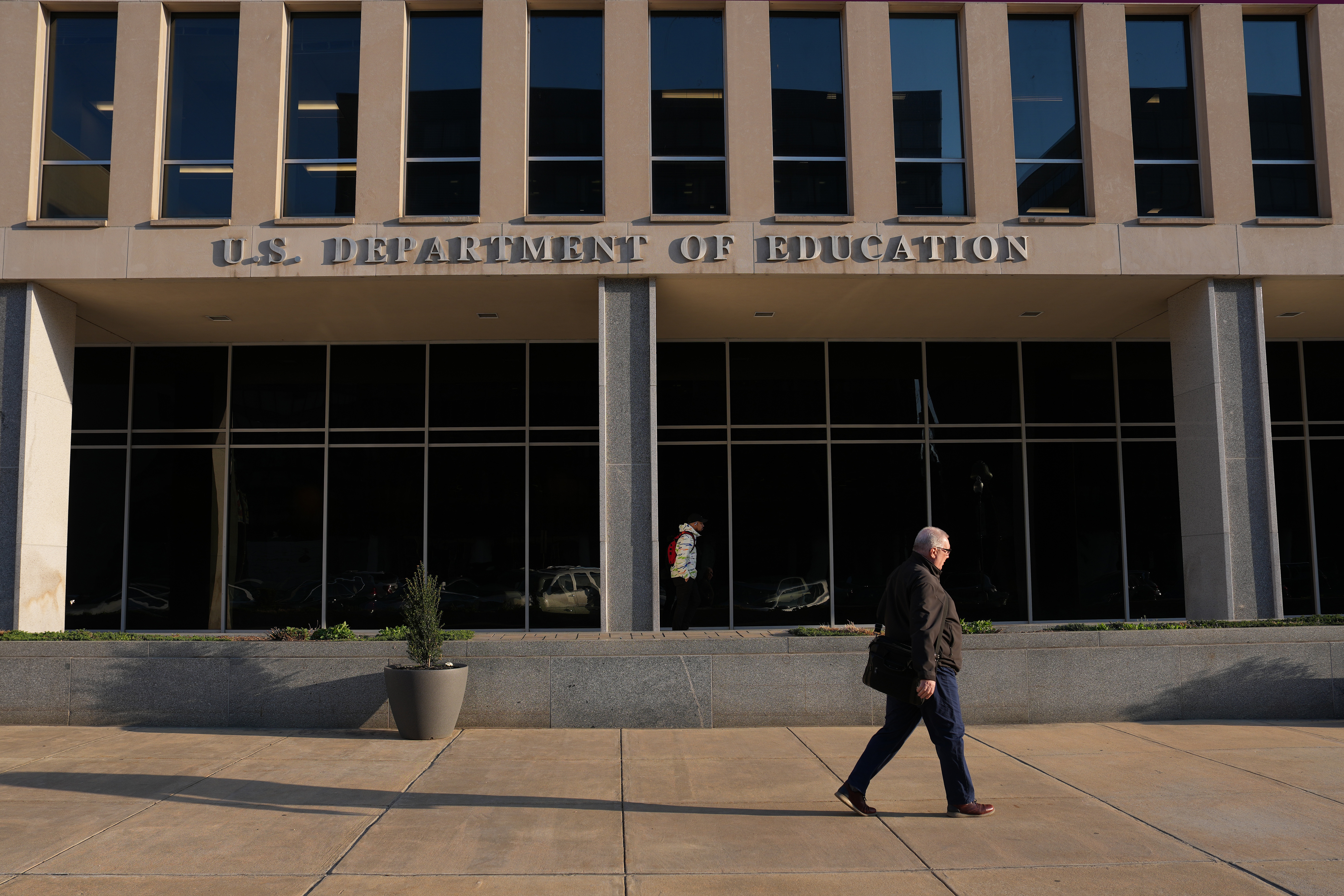 A person walks past the U.S. Department of Education in Washington, D.C. A lawsuit from a federal workers union argues changes to employees